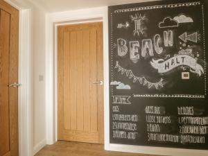 a room with a chalkboard wall with a door at The Beach Halt in Perranporth