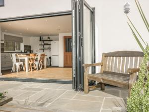a sliding glass door leading to the kitchen and dining room of a house at The Beach Halt in Perranporth