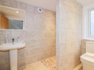a bathroom with a sink and a toilet at The Beach Halt in Perranporth