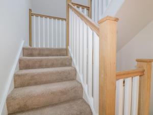 a stairway with a set of stairs with wooden railings at The Beach Halt in Perranporth