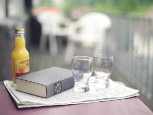 a book and a bottle of beer and glasses on a table at Gästehaus Spieker in Horn-Bad Meinberg
