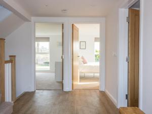 a hallway with a door leading to a bedroom at The Beach Halt in Perranporth