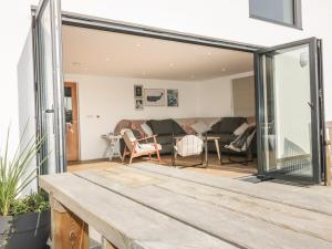 a living room with a large sliding glass door at The Beach Halt in Perranporth