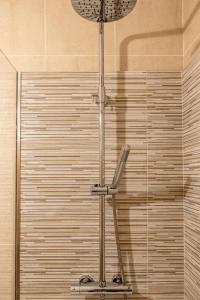 a shower in a bathroom with a glass wall at Madalena Beach Apartment by MP in Madalena