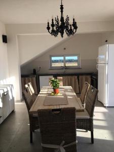 a dining room table with chairs and a chandelier at Casa Vigna da Michela in Favignana