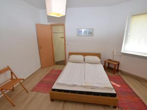 a bedroom with a bed in the middle of a room at Apartment in Bohemian with Private Terrace in Dolní Lánov