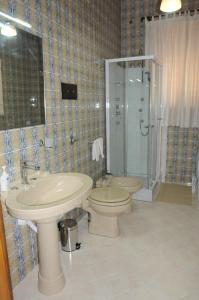 a bathroom with a toilet and a sink and a shower at CASA CALISI in Terrasini