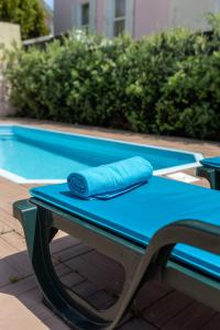 a blue towel sitting on top of a table next to a pool at Aguda Beach Charming House By PortoProperties4You in Vila Nova de Gaia