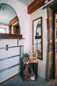 a room with a door and a mirror at The Rookery Nook and Brontë Parsonage - Haworth in Haworth