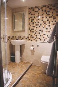 a bathroom with a sink and a toilet at The Throckmorton in Alcester