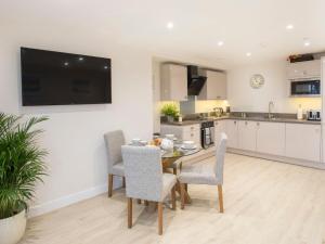 a kitchen and dining room with a table and chairs at The Beach Pad in Benllech