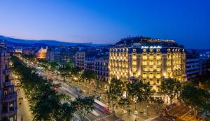 a large building on a city street at night at Majestic Hotel & Spa Barcelona GL in Barcelona