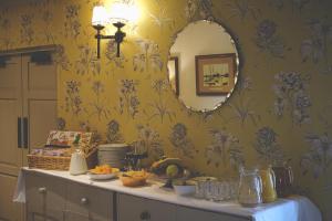 a room with a mirror and a table with food at The Mill at Conder Green in Conder Green