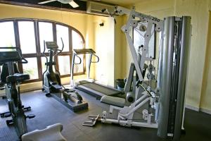 a gym with several tread machines in a room at Lindo Mar Resort in Puerto Vallarta
