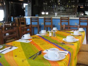 a table with a yellow and green table cloth at Lindo Mar Resort in Puerto Vallarta +14 photos