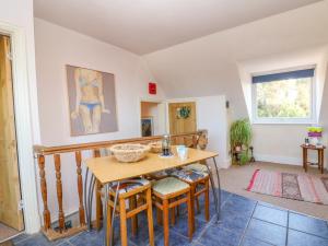 a dining room with a table and chairs at 4 Greenhills in Folkestone