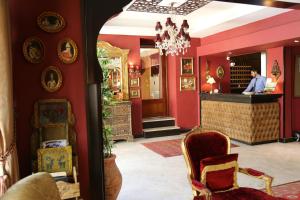 a man standing at the bar in a restaurant at Gondola Hotel & Suites in Amman