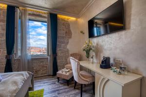 a hotel room with a desk and a window at Riva Palace - design rooms in Zadar