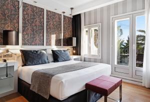 a bedroom with a large bed and a window at Catalonia Reina Victoria in Ronda