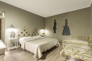 a bedroom with a bed and a dresser at Hotel Del Borgo in Bologna