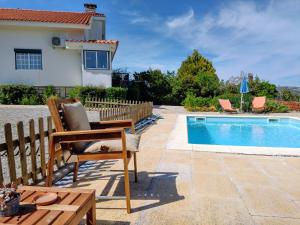 a villa with a swimming pool and a house at Quinta do Sol in Alijó