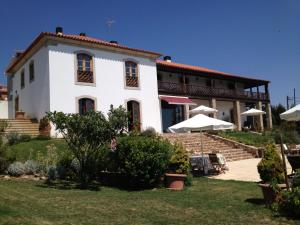 uma grande casa branca com um quintal em frente em Quinta Da Pereira E Enricas Agro-Turismo em Vila Flor