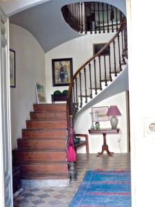 a staircase in a home with a wooden stair case at Olmitos 3, Casa-Palacio Real Piedad in Cehegín