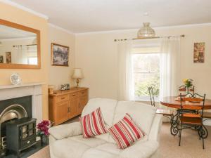 a living room with a white couch and a fireplace at Saltwood in Eastbourne