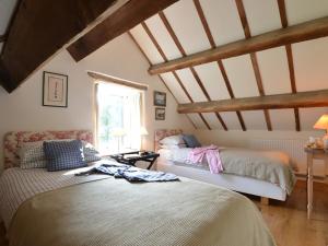 a bedroom with two beds and a window at Cefn Isaf in Porthmadog