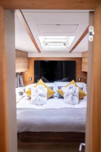 a bedroom with a large bed with yellow pillows at SEA-E-O in Lymington