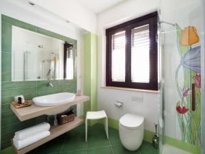 a bathroom with a sink and a toilet and a mirror at Hotel Sirius in Taormina
