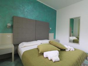 a bedroom with a bed with towels on it at B&B Villa Bea in San Vito lo Capo