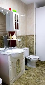 a bathroom with a white sink and a toilet at RINCON DO MAR ArenaBlanca in A Guarda +69 photos