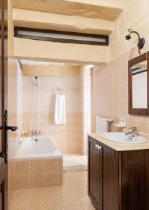 a bathroom with a tub and a sink at Villayana Holiday Home in San Lawrenz