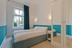 A bed or beds in a room at Imperial Apartments Helska
