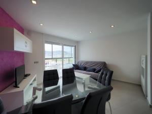 a living room with a glass table and a couch at InmoSantos Oasis A3 in Roses +9 photos