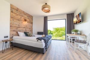 a bedroom with a bed and a wooden wall at Villa Dwa Morza in Jastarnia