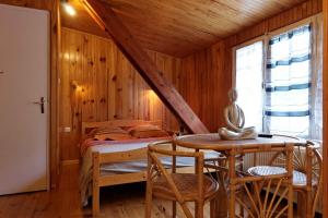 a bedroom with a bed and a table in a room at Chambres d'hotes à Autun in Autun
