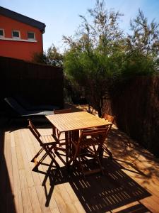 - une table en bois et 2 chaises sur la terrasse dans l'établissement L'horizon - Bord de mer, à Ploemeur