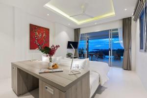 a living room with a couch and a table at Single Level BEACHSIDE VILLA - BB2 - at BAYSIDE LUXURY VILLAS Samrong Bay Beach, 3 BED 4 BATH, SEA and SUNSET VIEWS, only 200m walk to the Beach in Bang Rak Beach