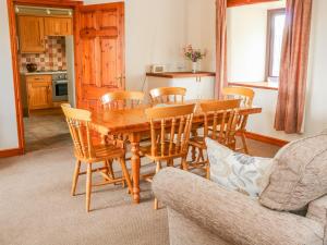 a dining room with a wooden table and chairs at The Barn in Skipton
