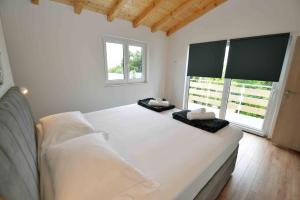 a bedroom with a large bed with two pillows on it at Holiday home Agata in Murter