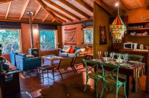 a living room with a table and chairs and a couch at CASA PATAY ELQUI in Monte Grande