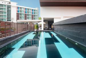 a swimming pool in the middle of a building at TSix5 Quarter in North Pattaya