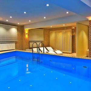 a large swimming pool in a hotel room at Kazakhstan Hotel in Atyraū