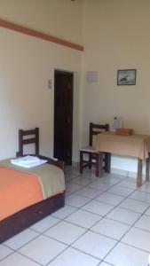 a room with two beds and a table in it at Hostal San Pablo in Yala