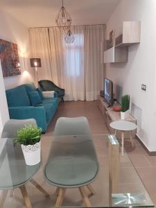 a living room with a blue couch and a table at POZO STYLE in Pozo Izquierdo