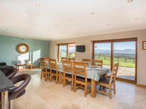 a dining room with a table and chairs at Dol Fraint in Llanfairpwllgwyngyll