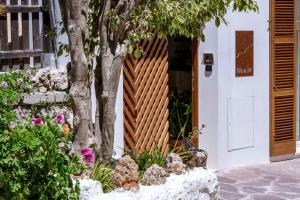 a garden entrance to a house with a wooden fence at Noualt in Ferreries