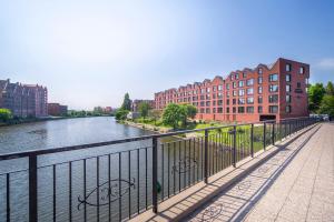 a bridge over a river in a city with buildings at MIRA APARTMENTS in Gdańsk